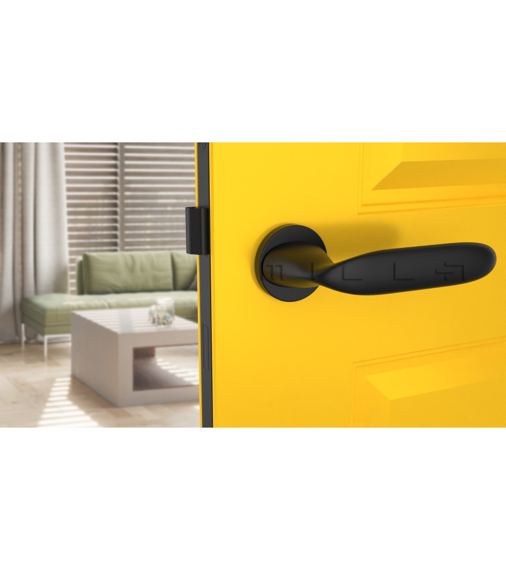 modern black door handle on yellow door