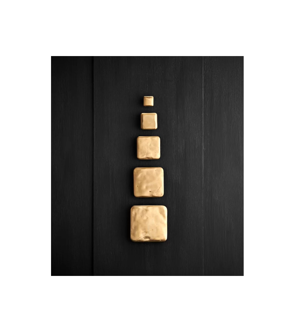 square gold handle on black furniture